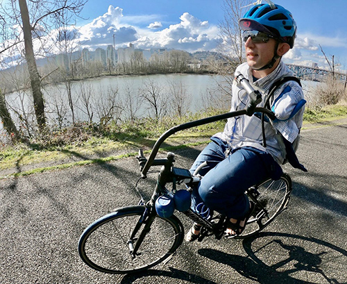 Michael Trimble riding his adaptive bicycle along the Spring Water Corridor Trail in Southeast Portland, Oregon.